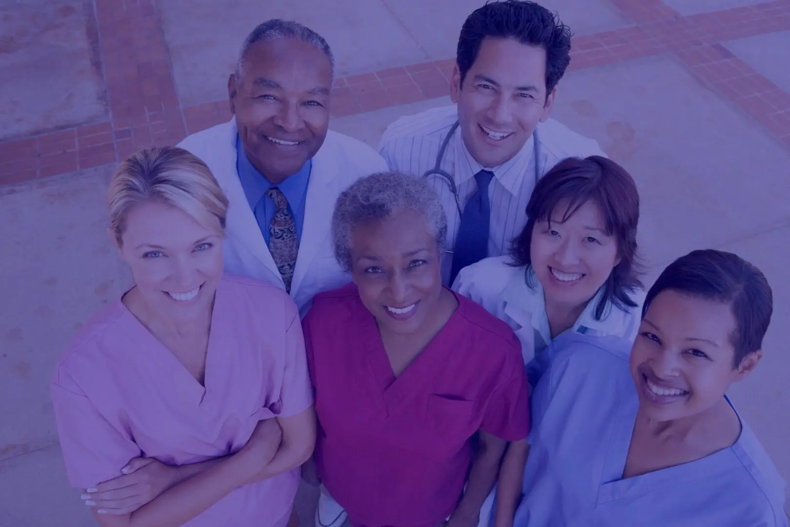 A group of doctors and nurses posing for the camera.